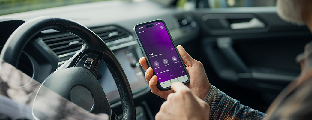 Image of person using the My Starkey app in their parked car